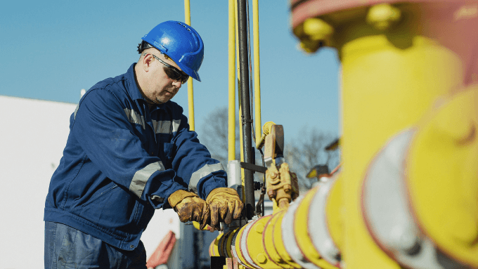 Image of a man working with the pipes